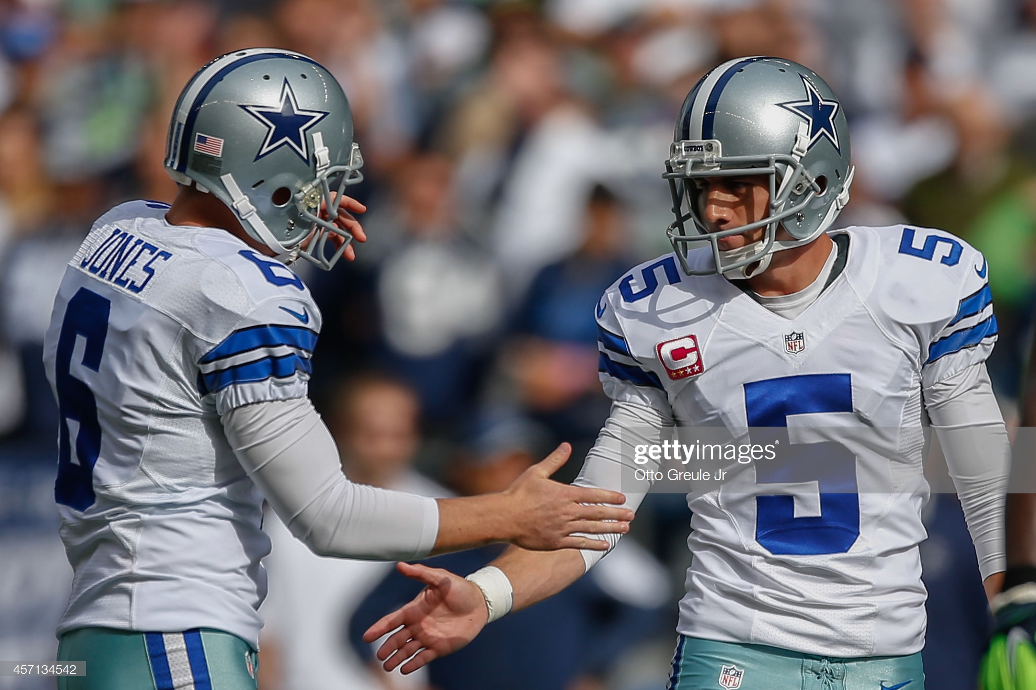 SEATTLE, WA - OCTOBER 12:  Kicker Dan Bailey #5 of the Dallas Cowboys is congratulated by holder Chris Jones #6 after kicking a field goal to tie the score at 10-10 in the second quarter against the Seattle Seahawks at CenturyLink Field on October 12, 2014 in Seattle, Washington. The Cowboys defeated the Seahawks 30-23.  (Photo by Otto Greule Jr/Getty Images)